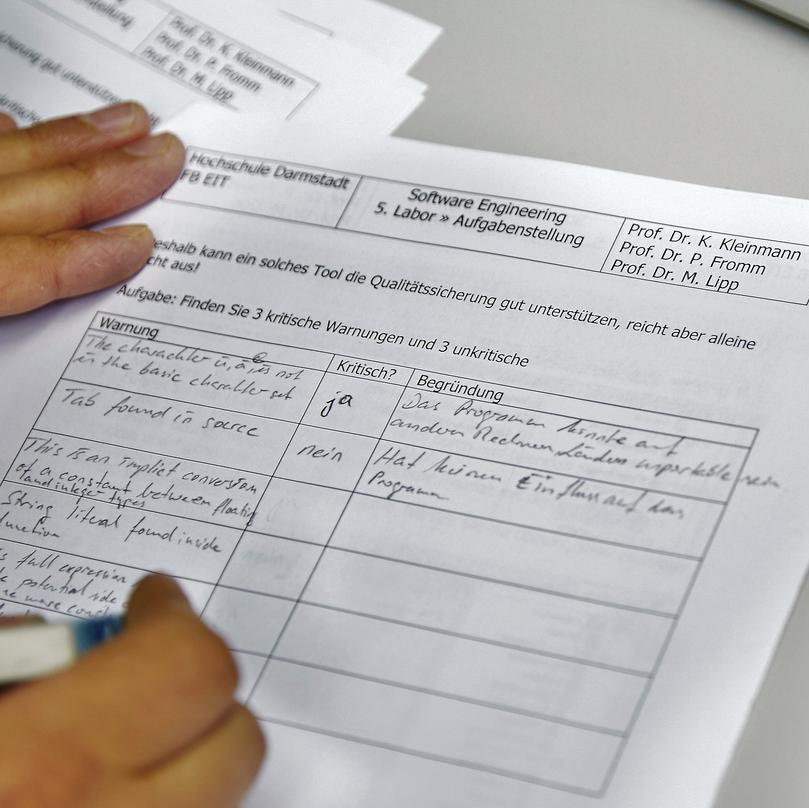 Student working taking notes on a piece of paper